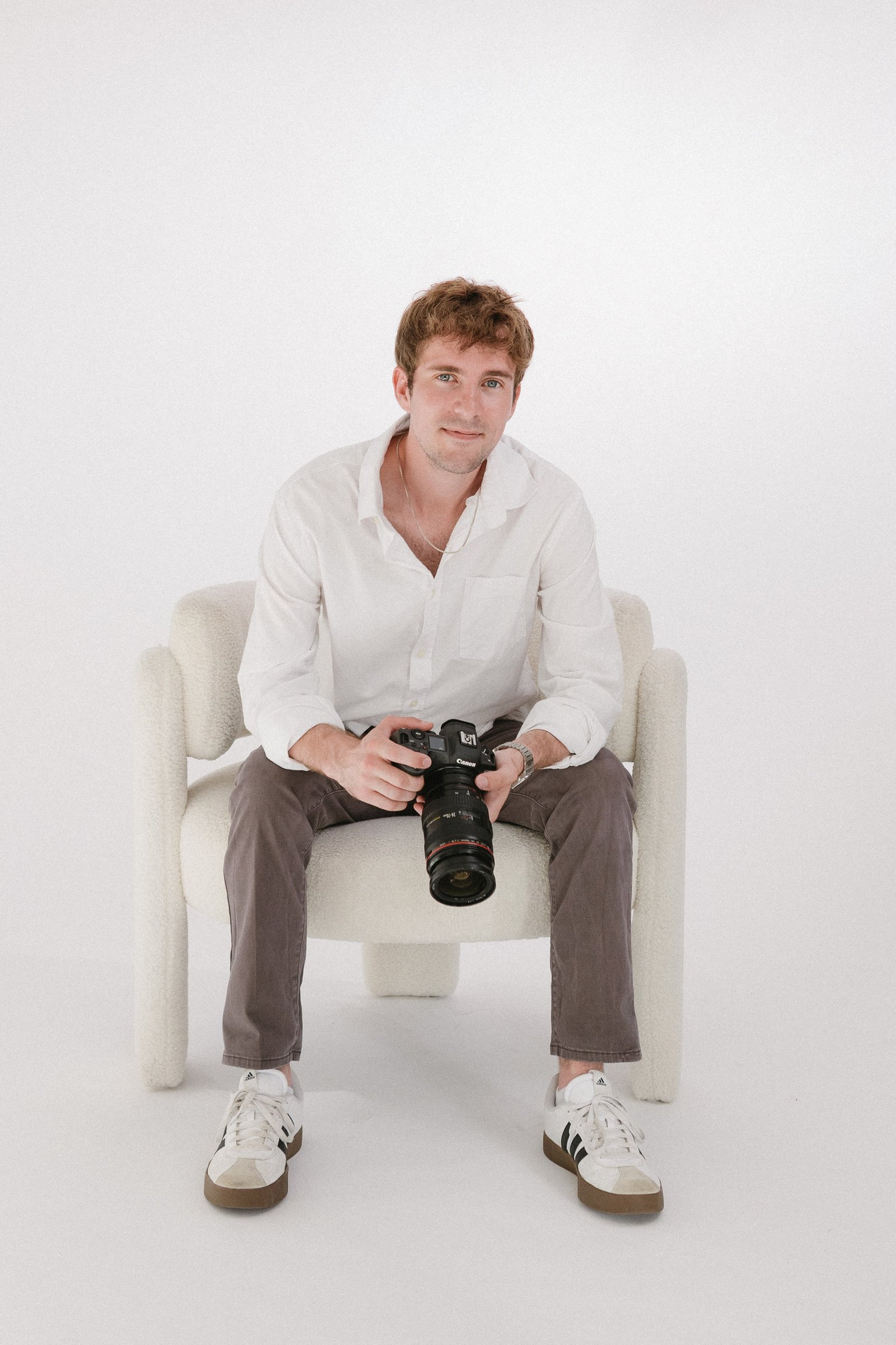 Luke Montgomery seated with his camera