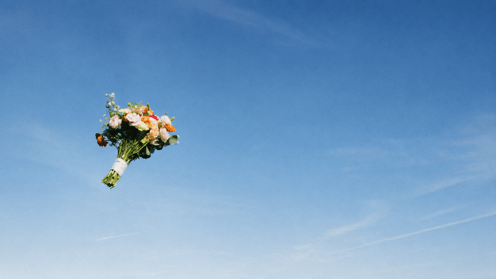 Bouquet floating against a soft blue sky