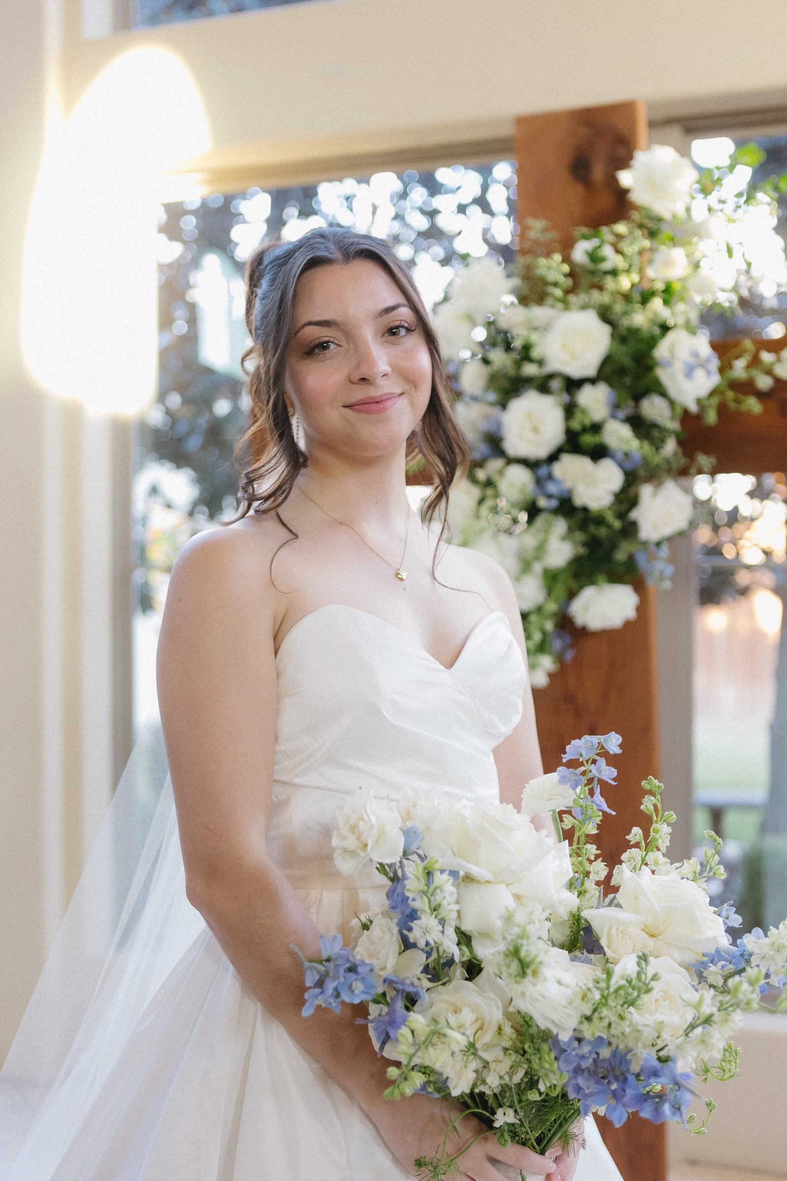 Bride holding a white and blue bouquet