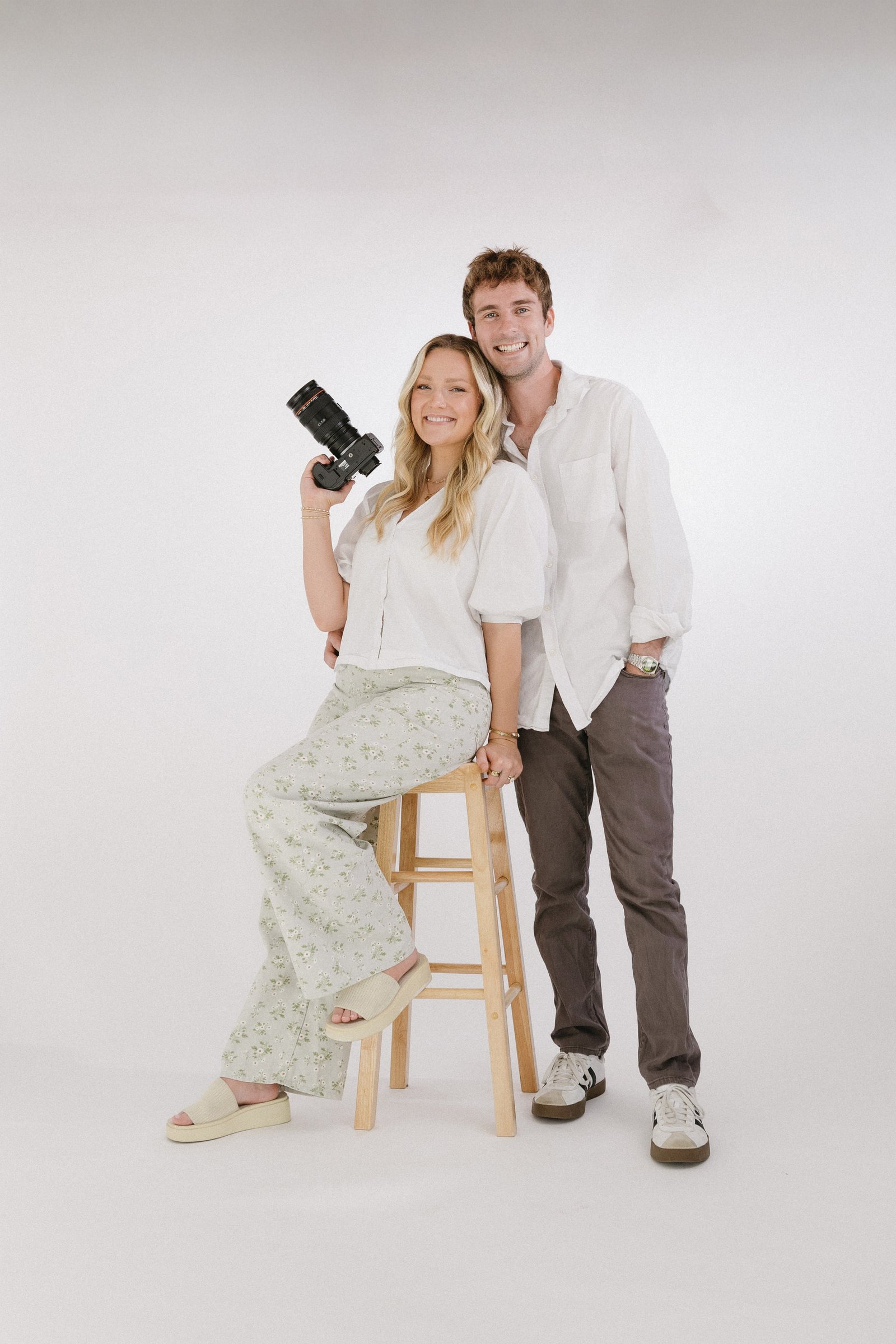Luke and Skyler Montgomery standing together in their photography studio